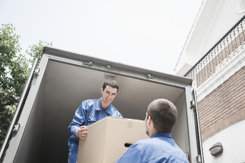 Professional movers carrying furniture from a suburban property in Croydon
